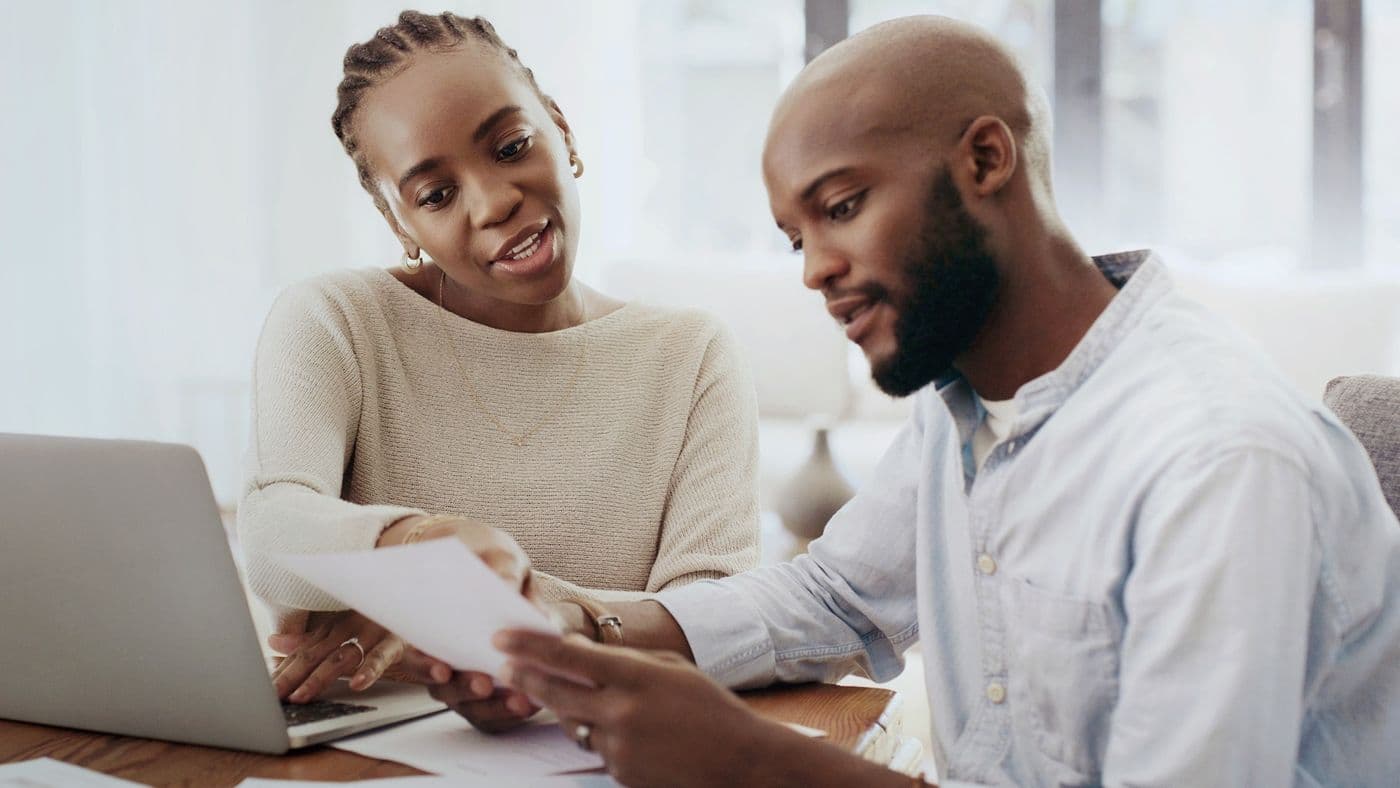 A couple at home looking at a laptop together